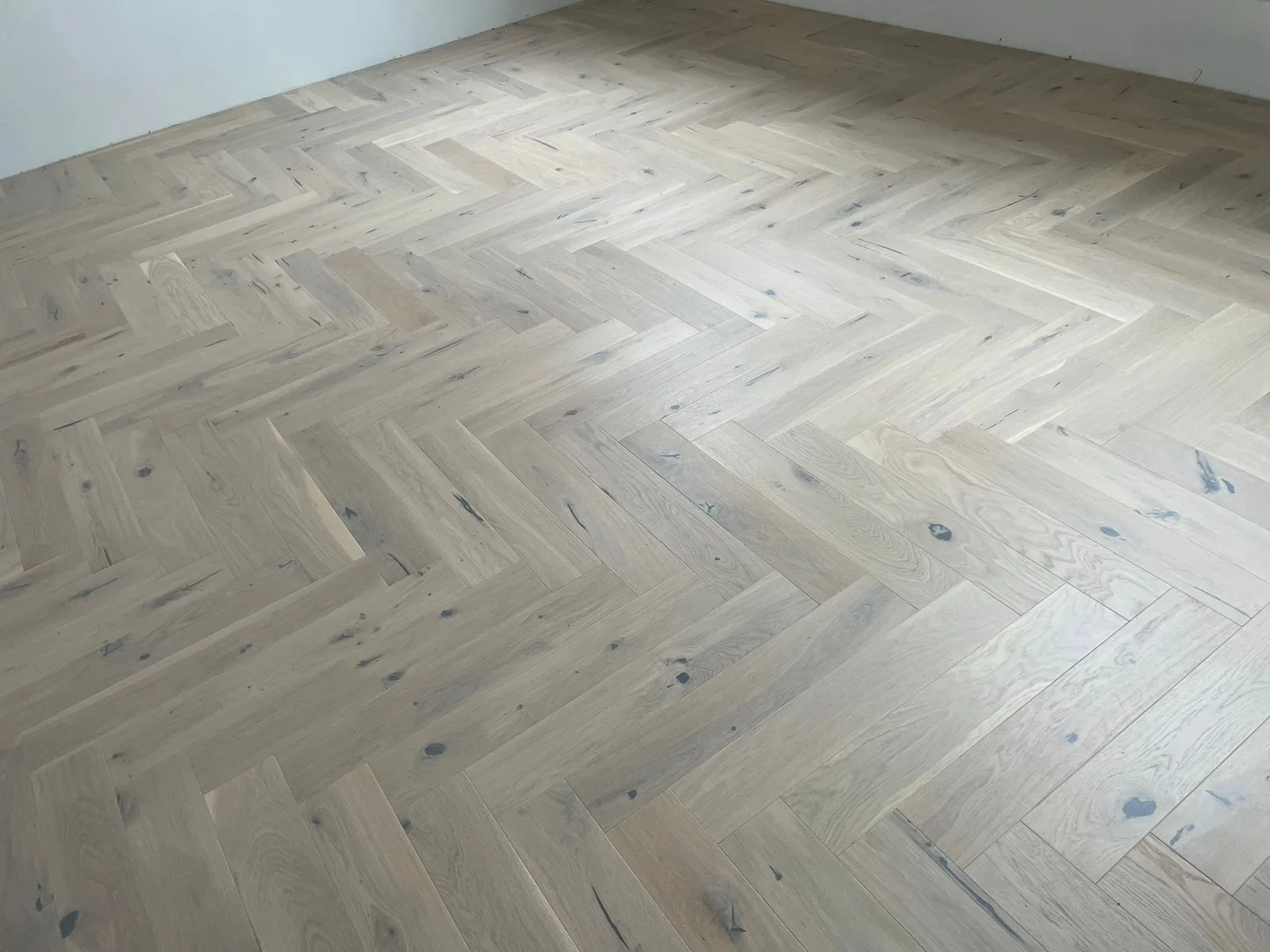Light room with herringbone-pattern flooring