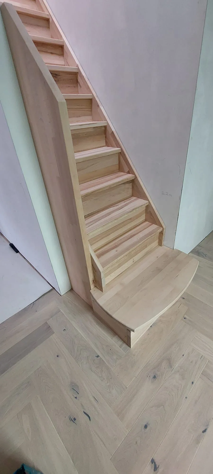 Timber staircase and herringbone-pattern flooring