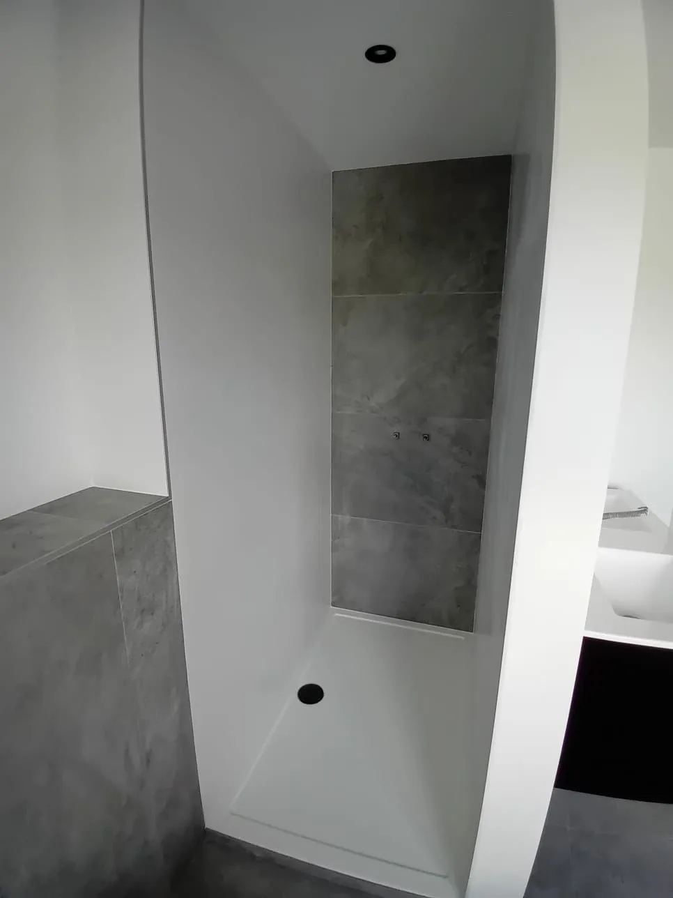 Shower area with grey tiling