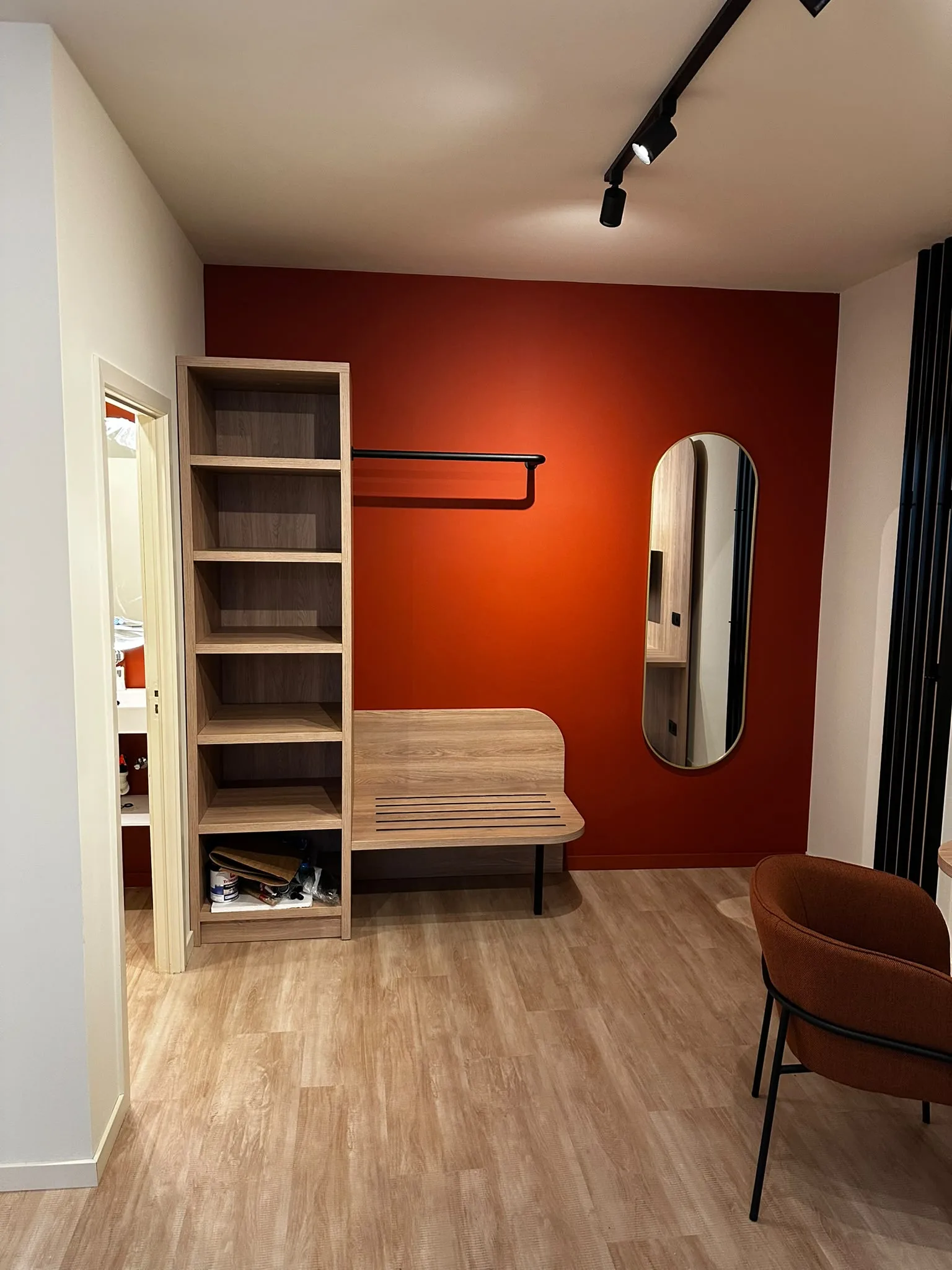 Wood-look furniture and a vertical mirror with rounded corners