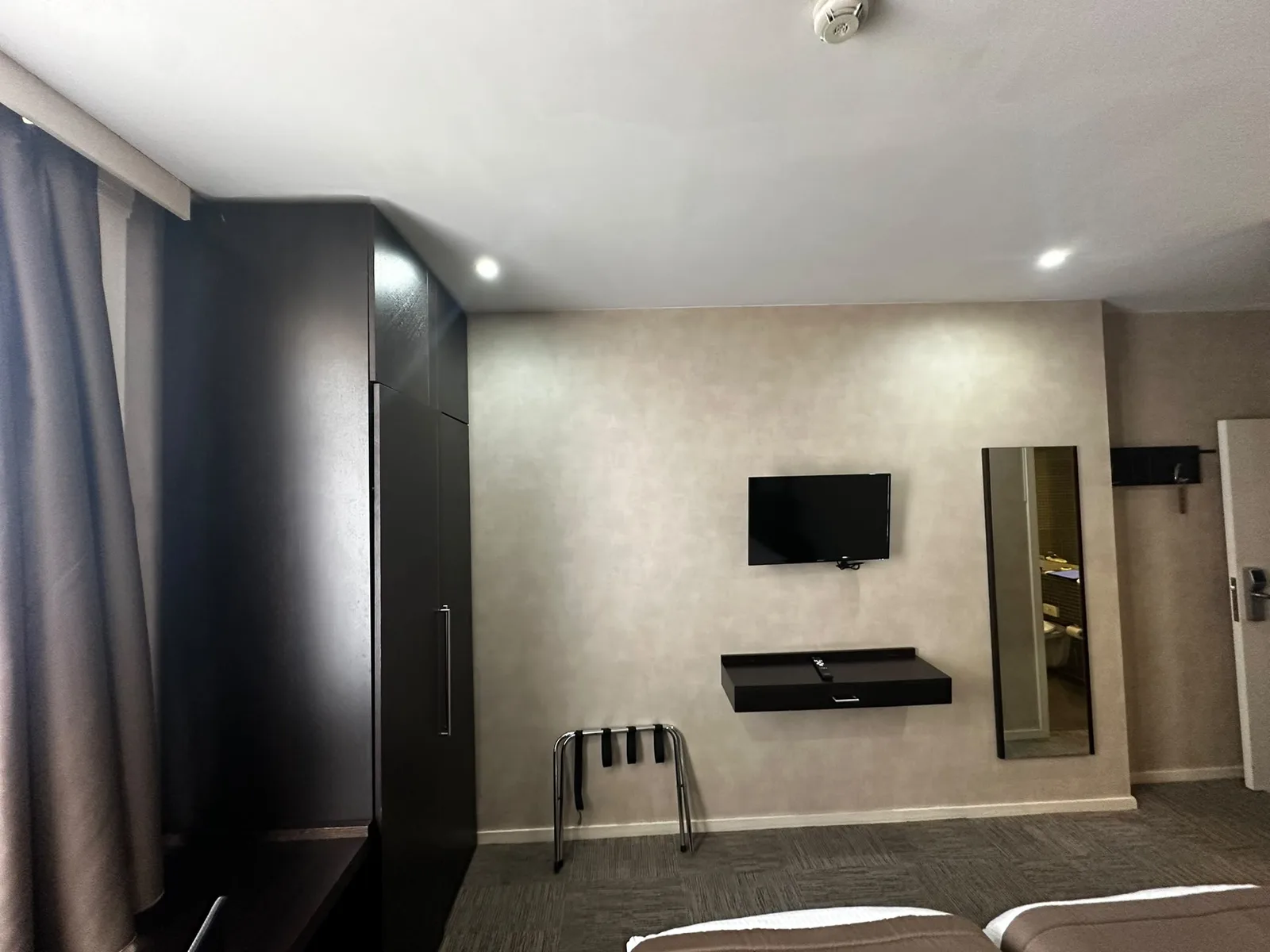 Previous dark furniture, television and carpeted floor