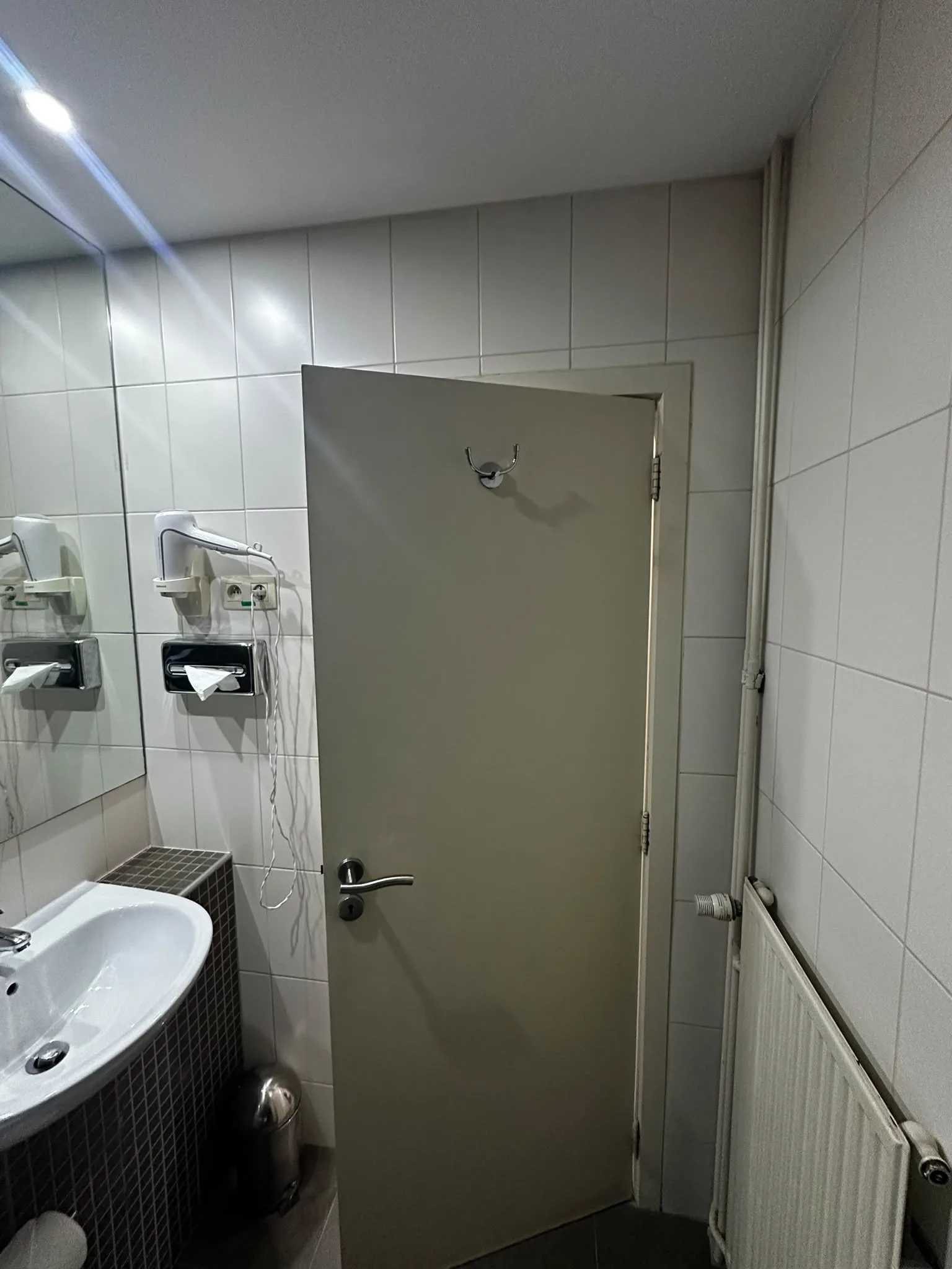 Previous white tiling, basin and radiator