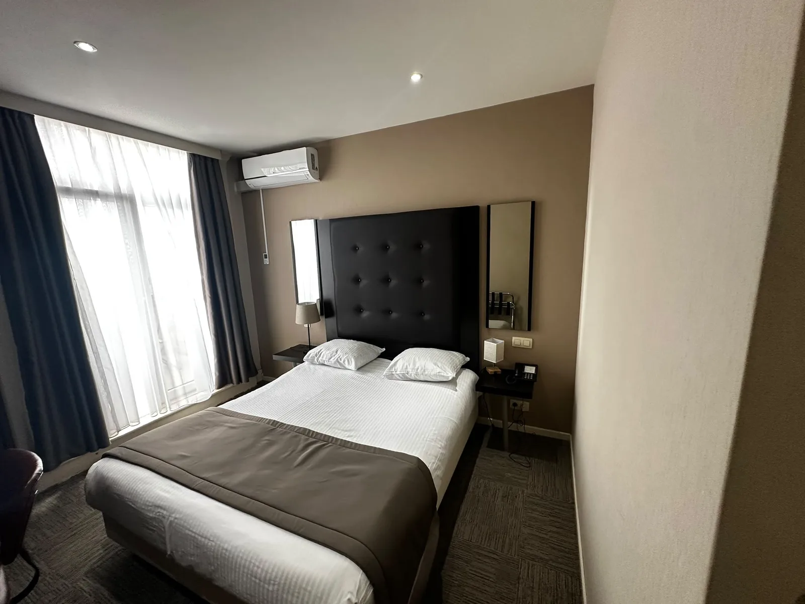 Previous upholstered headboard and dark bedside tables