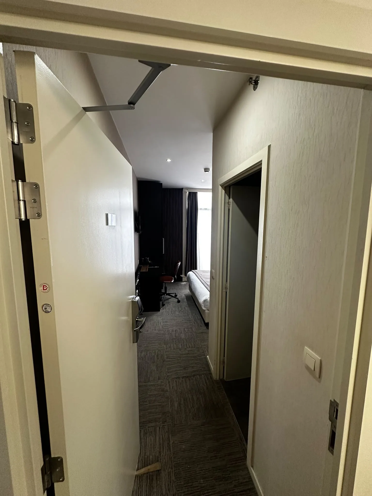 Previous room entrance with carpeted flooring