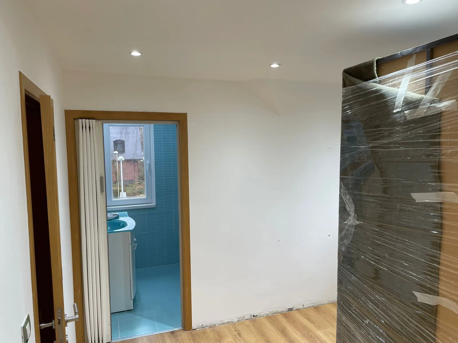 Room beneath the roof with recessed lighting