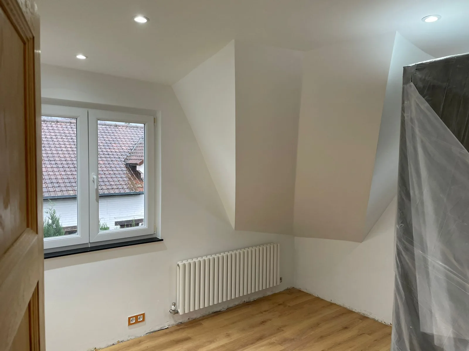Room beneath the roof with recessed lighting