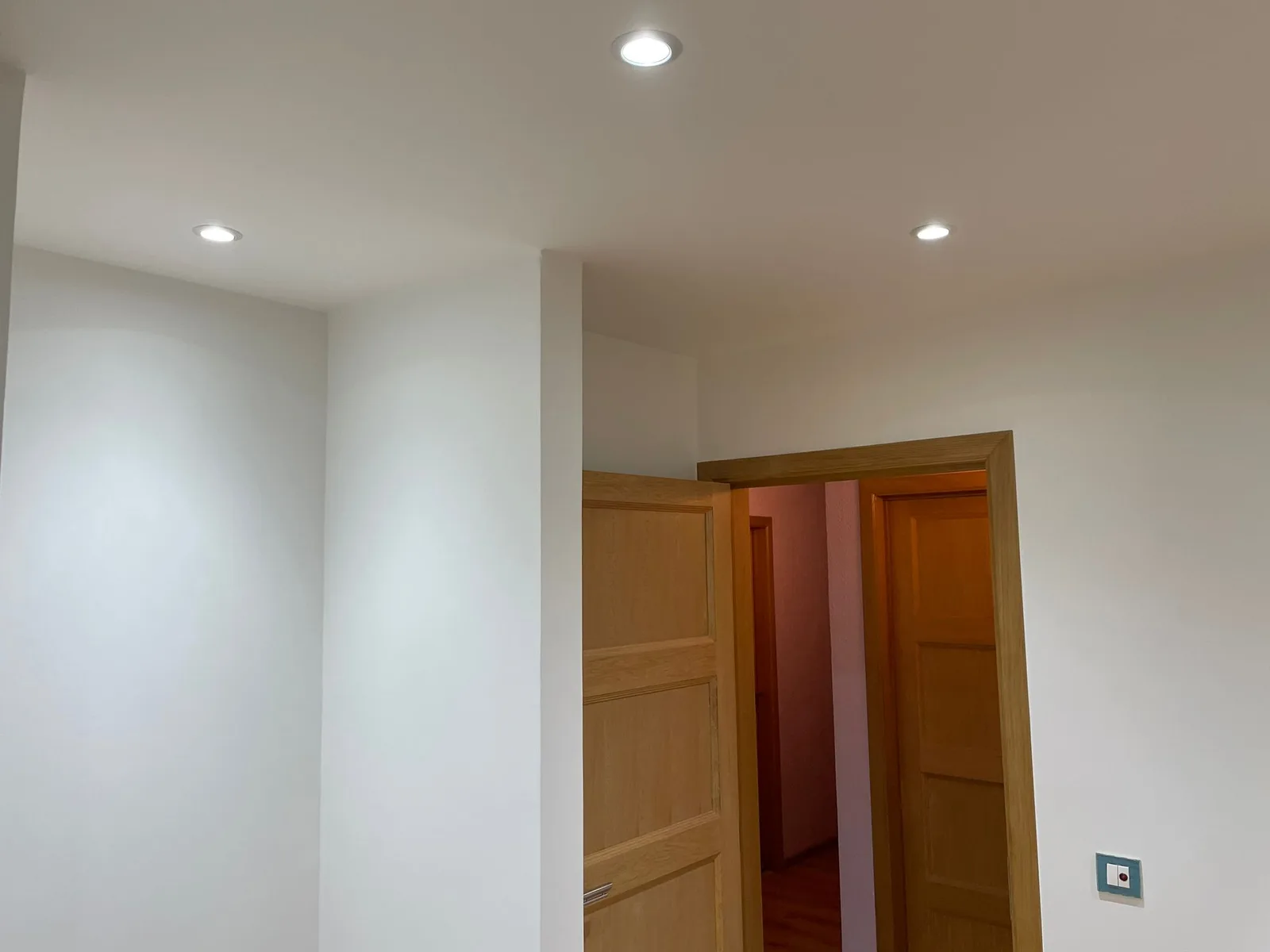 Room beneath the roof with recessed lighting