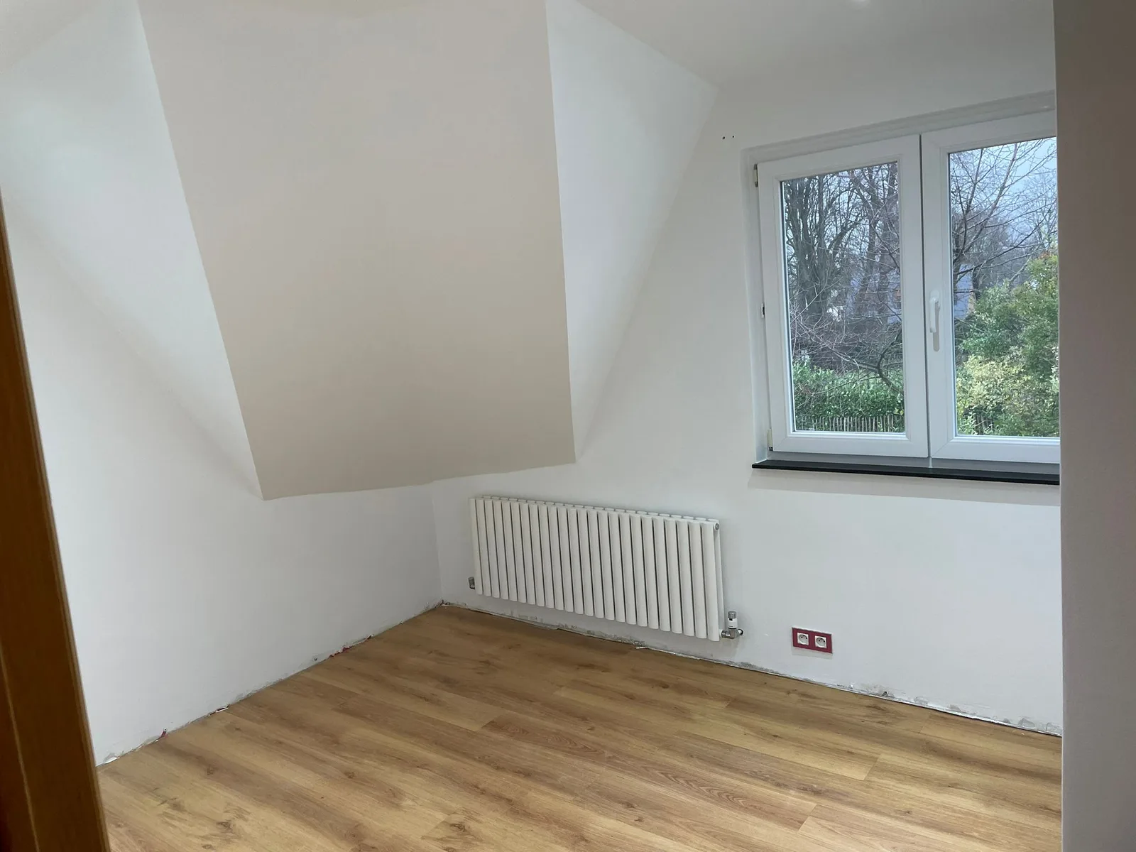 Room beneath the roof with recessed lighting