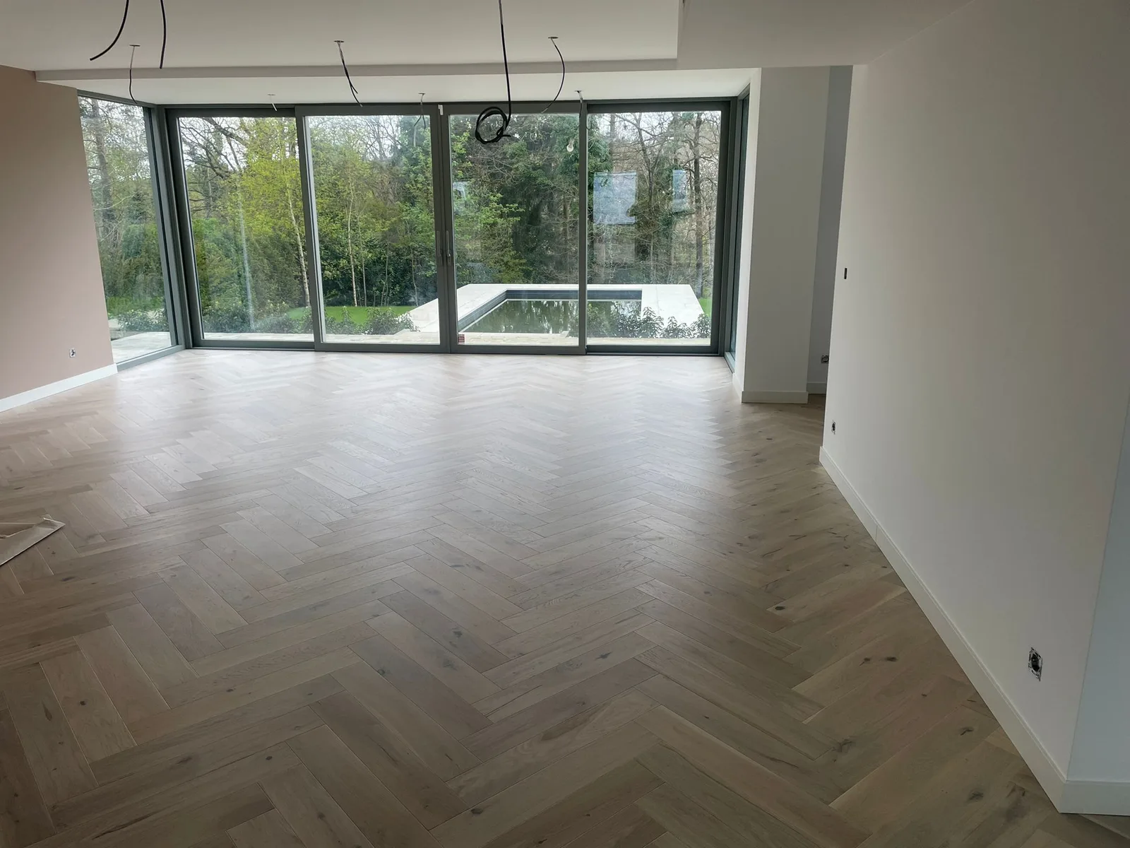 Living space with herringbone-pattern flooring