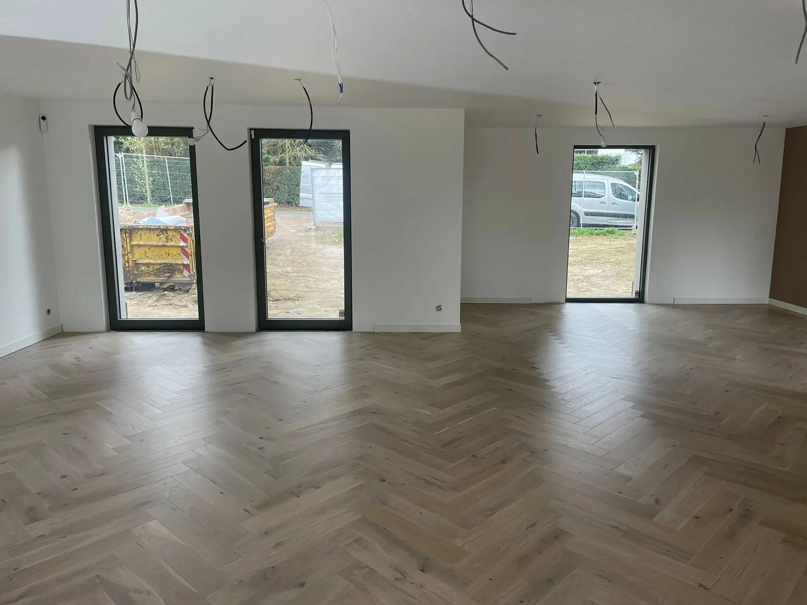 Living space with herringbone-pattern flooring
