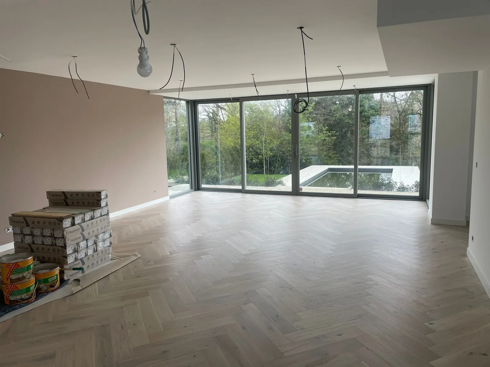 Living space with herringbone-pattern flooring