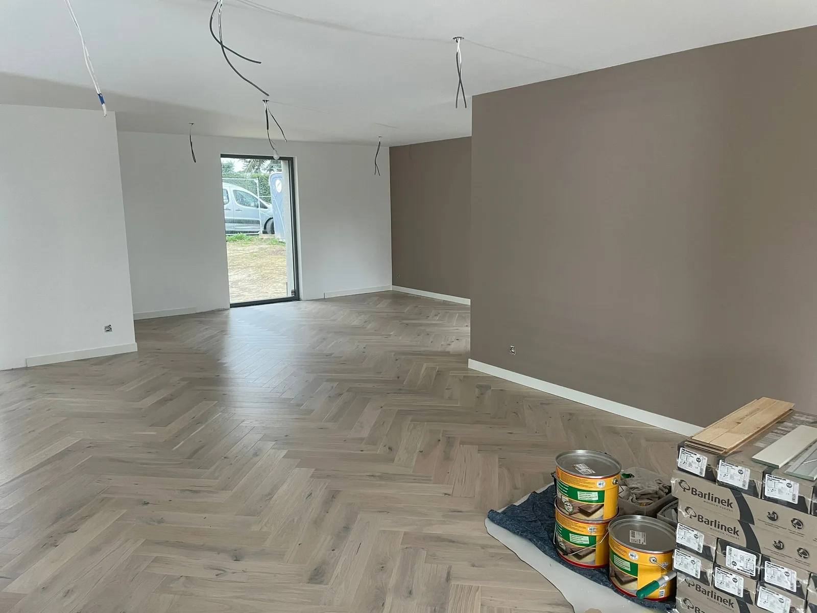 Living space with herringbone-pattern flooring