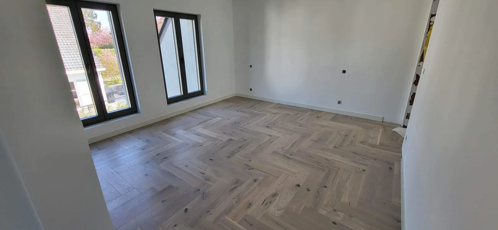 Living space with herringbone-pattern flooring