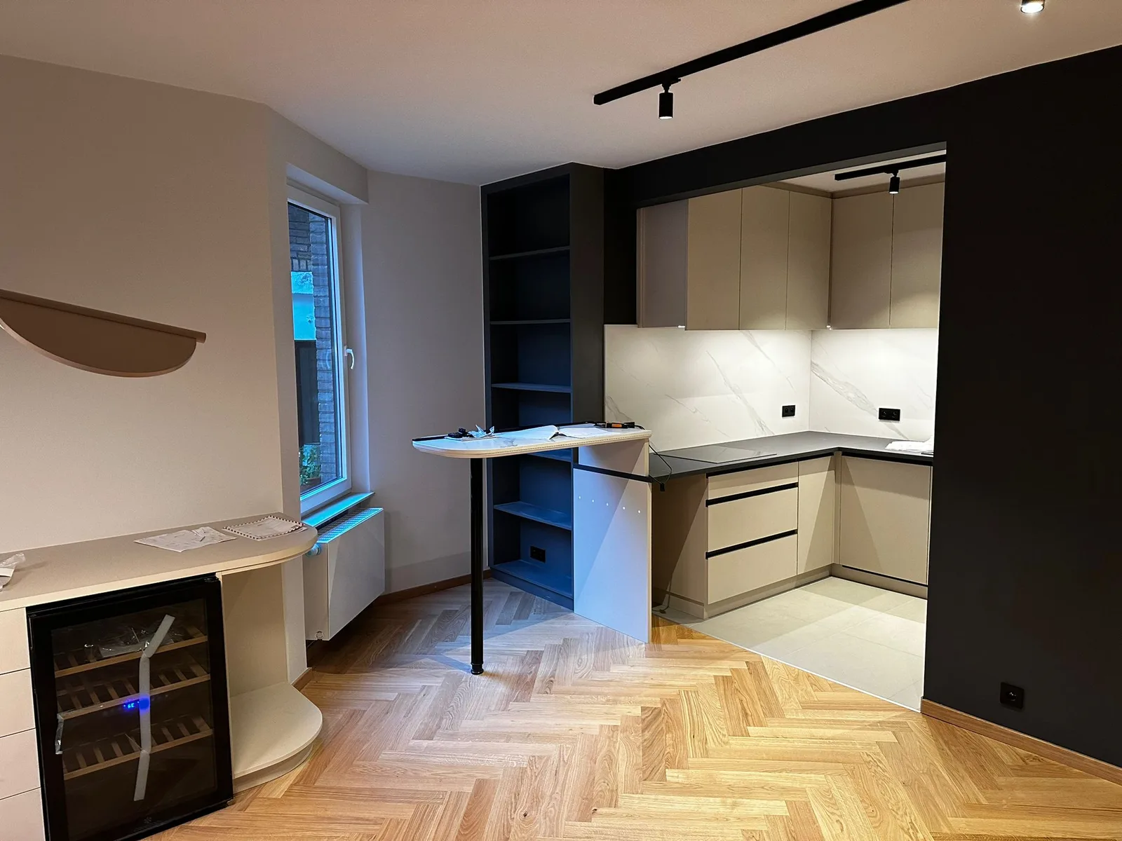 Kitchen and storage with herringbone-pattern flooring