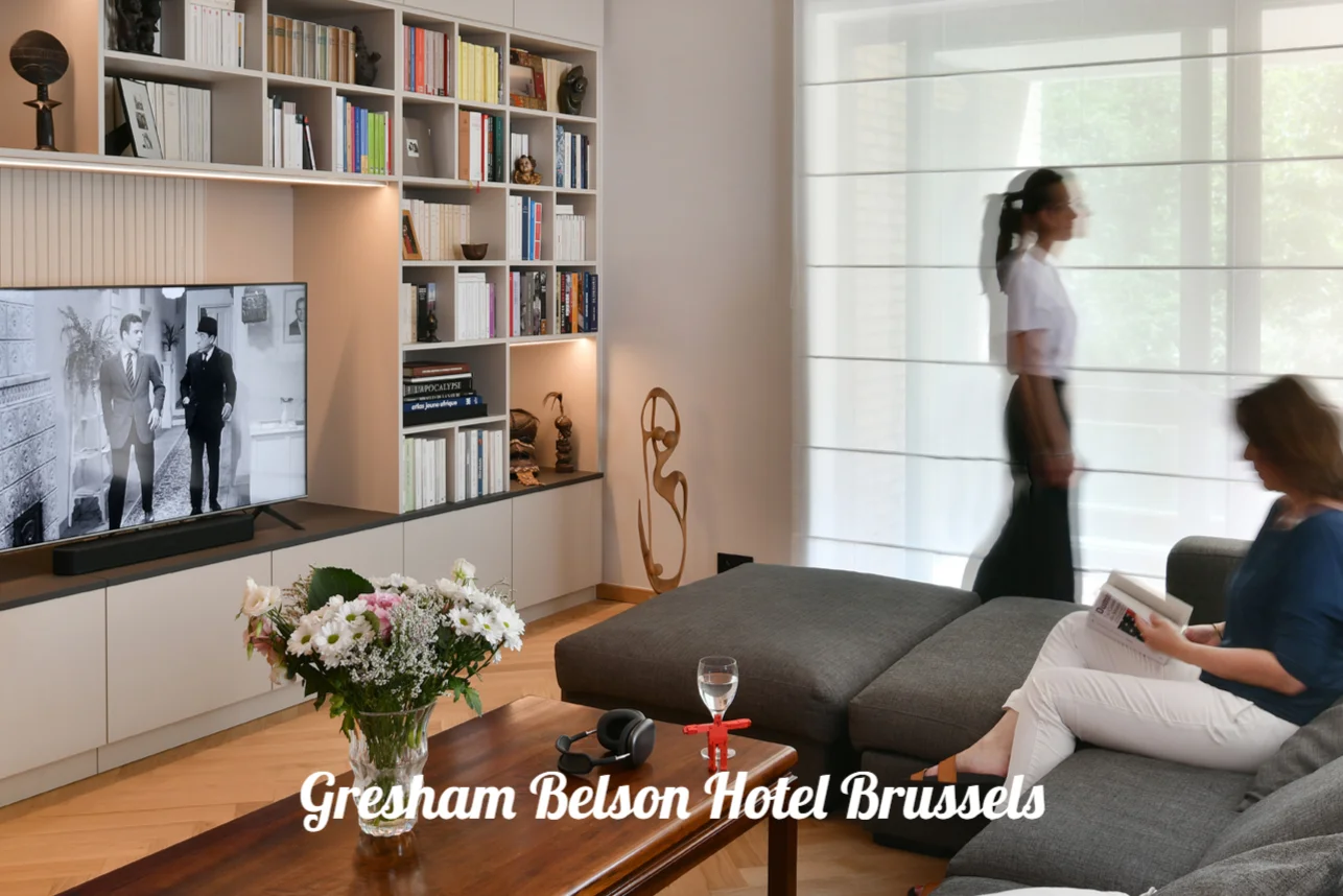 Lounge with bookshelves, a sofa and large windows