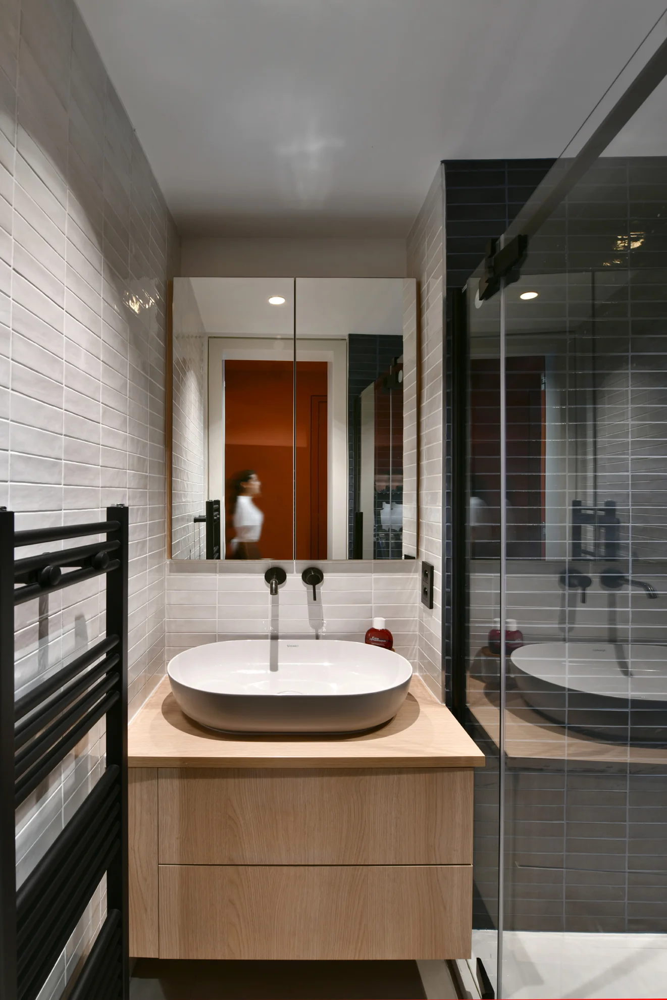 Vanity and shower with grey tiling