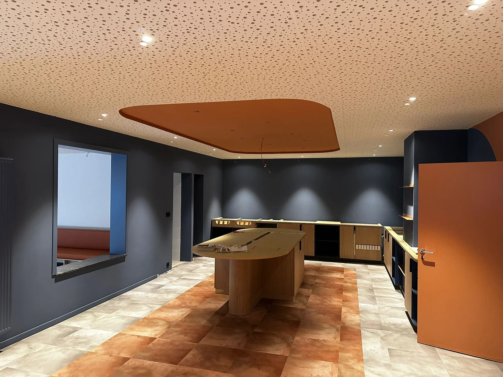 Dining area with a buffet and perforated ceiling